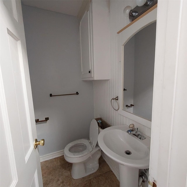 bathroom featuring sink, tile patterned floors, and toilet