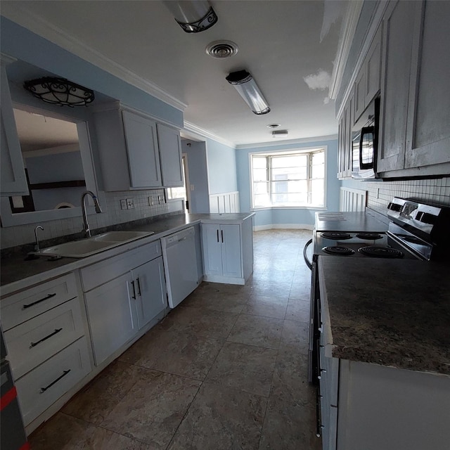 kitchen with white dishwasher, sink, white cabinetry, and kitchen peninsula