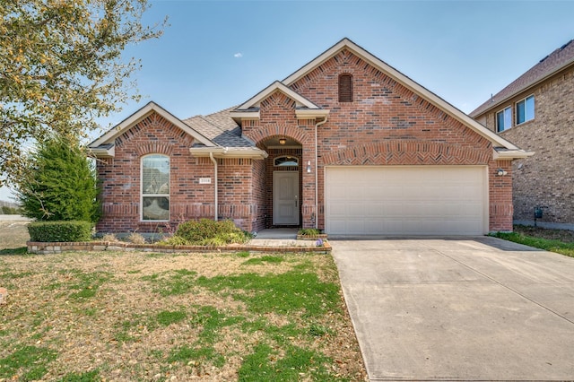 view of front of property with a garage, brick siding, and concrete driveway