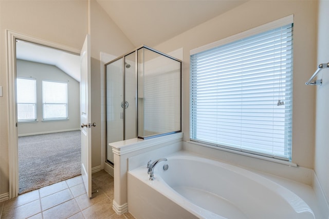 full bath featuring lofted ceiling, a garden tub, a shower stall, and tile patterned flooring