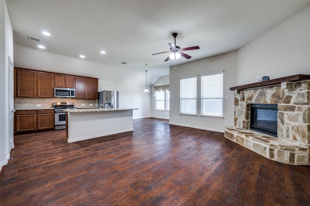 kitchen with visible vents, appliances with stainless steel finishes, open floor plan, and dark wood-style flooring