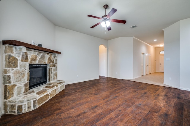 unfurnished living room featuring a fireplace, wood finished floors, baseboards, and ceiling fan