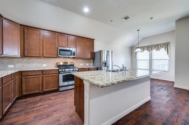 kitchen featuring visible vents, dark wood finished floors, lofted ceiling, stainless steel appliances, and a sink