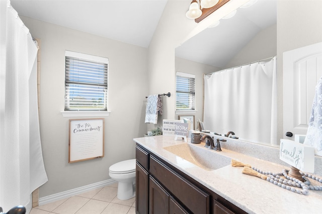 bathroom with tile patterned flooring, vanity, lofted ceiling, and toilet