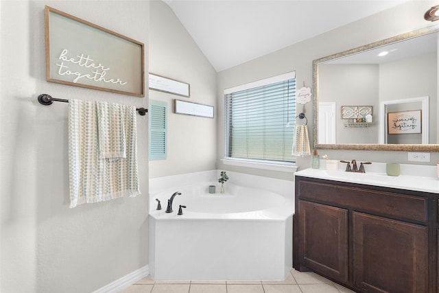 bathroom with a washtub, vanity, tile patterned flooring, and vaulted ceiling