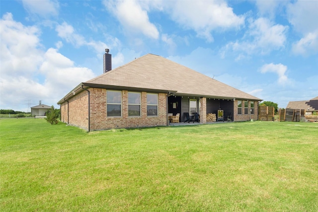 rear view of house featuring a yard