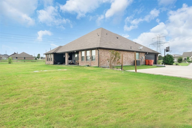 back of house featuring cooling unit and a lawn