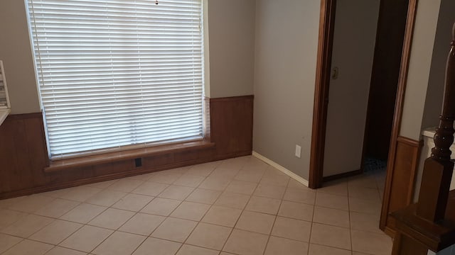 spare room featuring wood walls