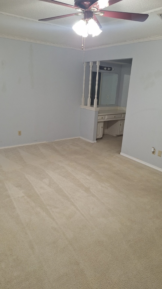 spare room with light colored carpet and a textured ceiling