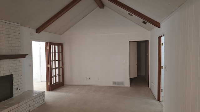 unfurnished living room with beamed ceiling, high vaulted ceiling, light colored carpet, and a fireplace