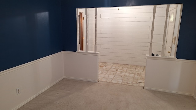 unfurnished room with light colored carpet