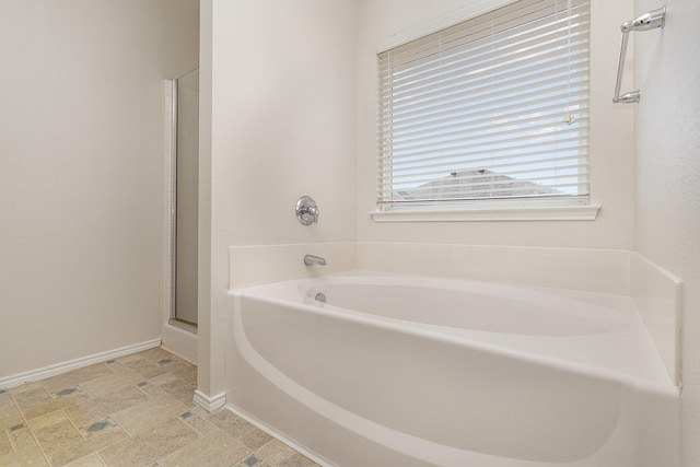 bathroom featuring separate shower and tub