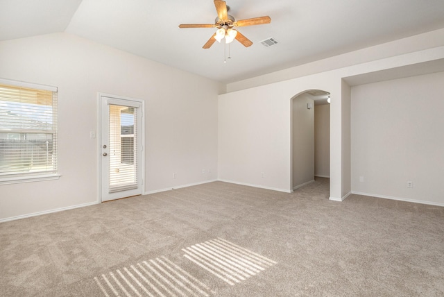 unfurnished room featuring lofted ceiling, light colored carpet, and ceiling fan