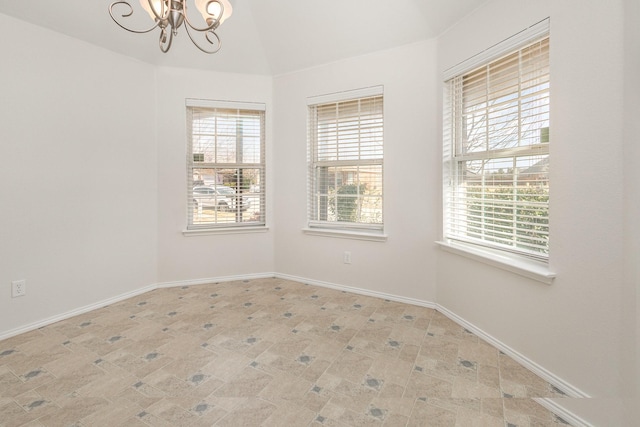 unfurnished room featuring plenty of natural light and a notable chandelier