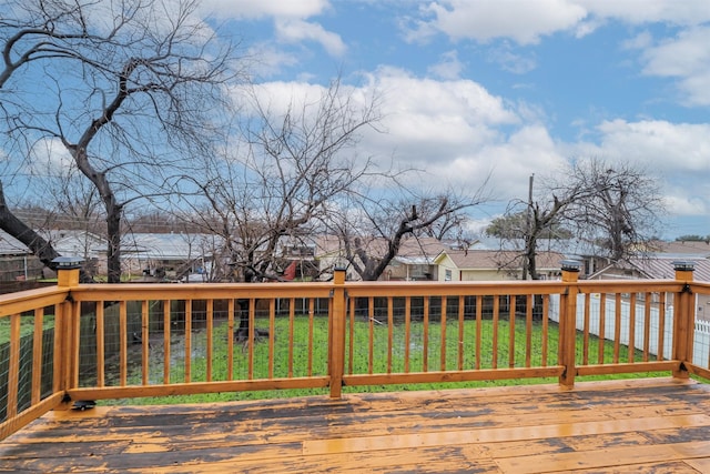 wooden deck featuring a yard