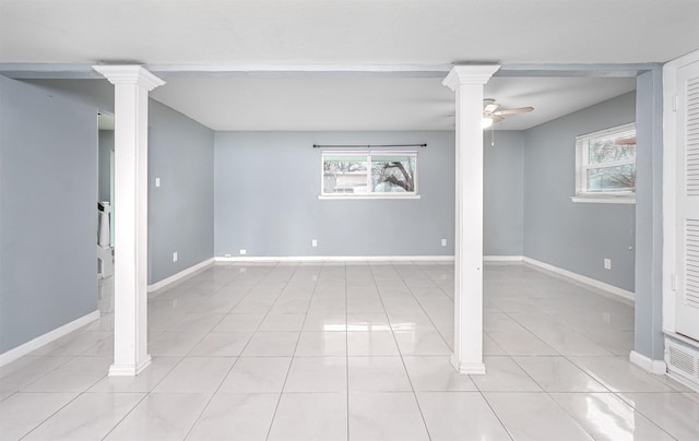 basement with ceiling fan, a healthy amount of sunlight, and light tile patterned floors