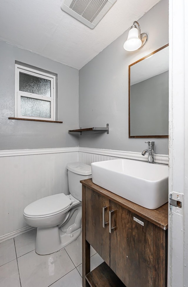 bathroom with vanity, tile patterned flooring, and toilet