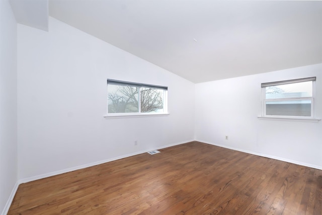 bonus room with lofted ceiling and dark wood-type flooring