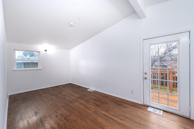 additional living space featuring plenty of natural light, dark hardwood / wood-style flooring, and vaulted ceiling with beams