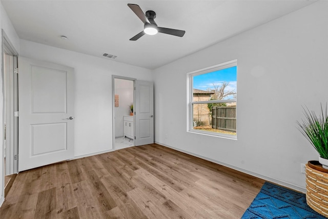 unfurnished bedroom with ceiling fan, connected bathroom, and light hardwood / wood-style floors