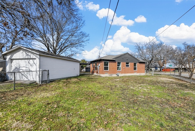 exterior space with an outbuilding, a yard, and a garage