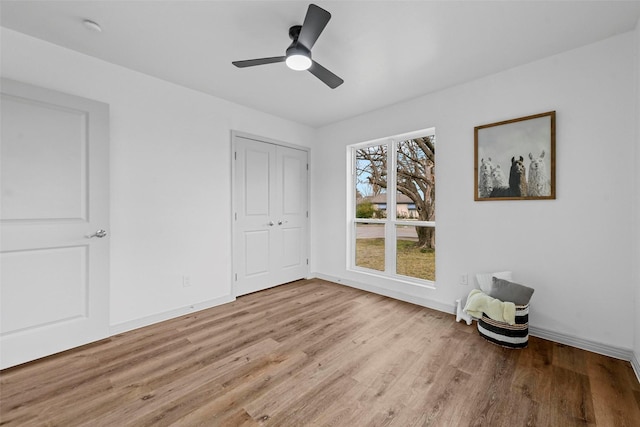 empty room featuring ceiling fan and light hardwood / wood-style floors