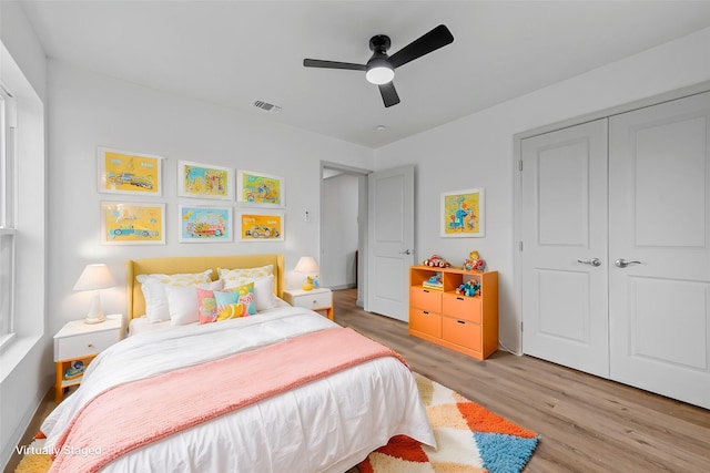 bedroom with a closet, ceiling fan, and light wood-type flooring