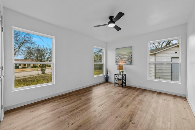 unfurnished room with light hardwood / wood-style flooring and ceiling fan