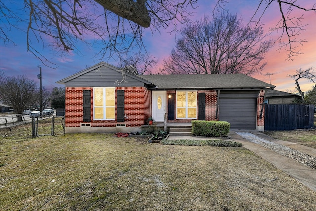 view of front facade featuring a garage and a yard