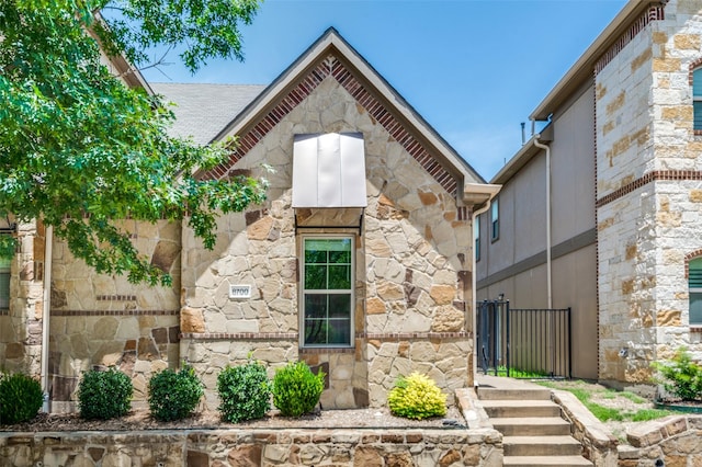 8700 Paradise Dr, Mckinney, TX 75070 - view of front facade featuring stone siding and fence
