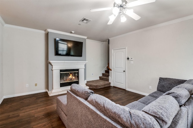 living room featuring crown molding, ceiling fan, and dark hardwood / wood-style flooring