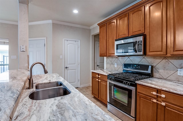 8700 Paradise Dr, Mckinney, TX 75070 - kitchen featuring appliances with stainless steel finishes, a sink, backsplash, light stone countertops, and crown molding