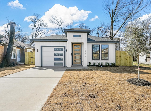 prairie-style home featuring a garage and a front lawn