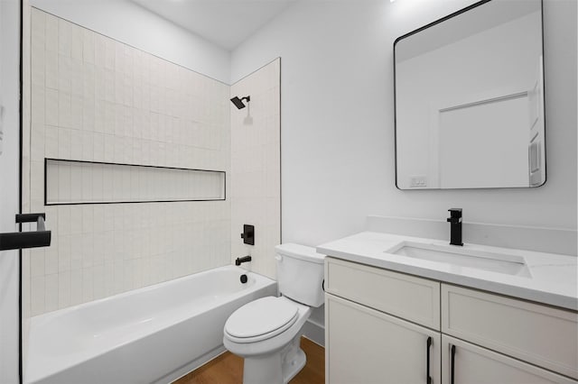 full bathroom with hardwood / wood-style flooring, vanity, toilet, and tiled shower / bath combo