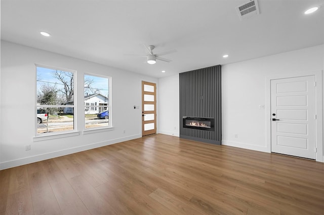 unfurnished living room with hardwood / wood-style floors and ceiling fan