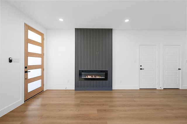 unfurnished living room featuring light wood-type flooring