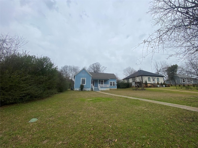 view of front of home with a porch and a front lawn