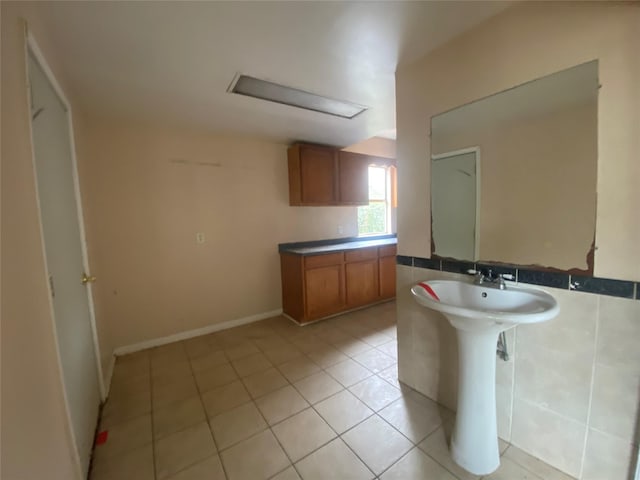 bathroom with sink and tile patterned flooring