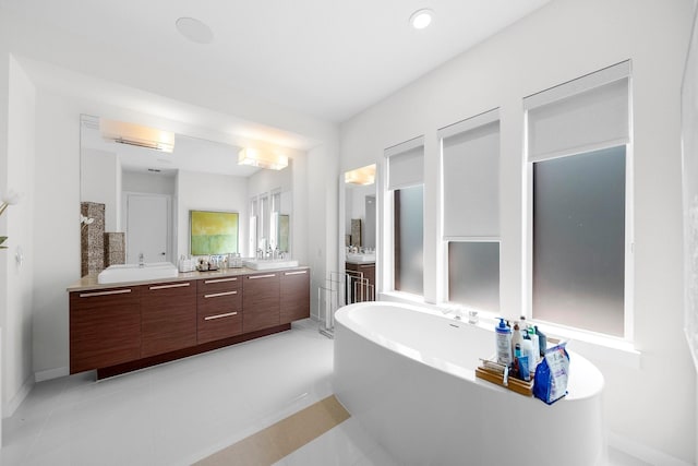 5399 Randwick Trl, Frisco, TX 75036 - bathroom with a freestanding tub, double vanity, a wall mounted AC, tile patterned flooring, and recessed lighting