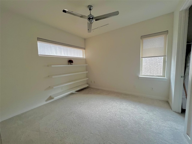 empty room with a wealth of natural light and ceiling fan