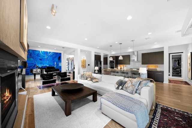 5399 Randwick Trl, Frisco, TX 75036 - living room featuring light wood-style floors, a fireplace, and recessed lighting