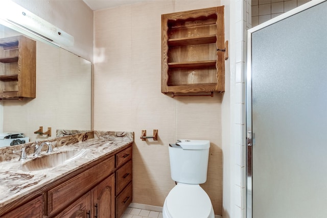 bathroom with vanity, toilet, and a shower with shower door