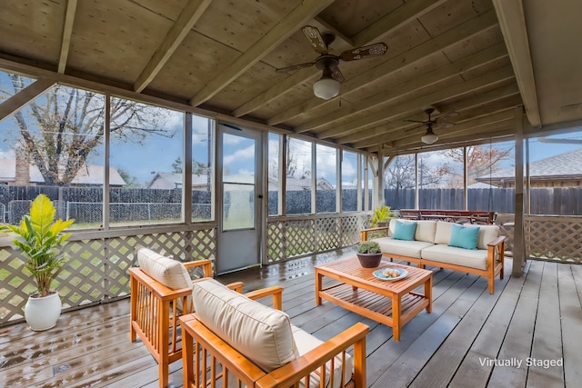 sunroom featuring wood ceiling and ceiling fan