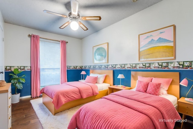 bedroom with ceiling fan and dark hardwood / wood-style flooring