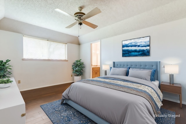 bedroom featuring ceiling fan, hardwood / wood-style flooring, vaulted ceiling, and a textured ceiling