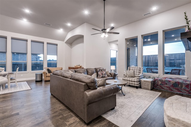 living area with dark wood-style floors, ceiling fan, visible vents, and recessed lighting