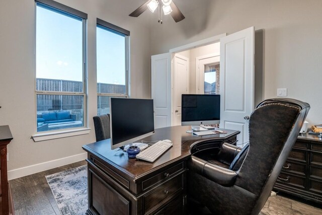 office space featuring a ceiling fan, dark wood-style flooring, and baseboards