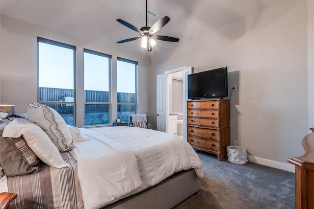 carpeted bedroom featuring a ceiling fan, visible vents, baseboards, and ensuite bathroom