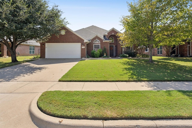 view of front of property featuring a garage and a front lawn