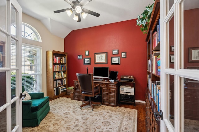 office space with french doors, ceiling fan, dark hardwood / wood-style flooring, and vaulted ceiling